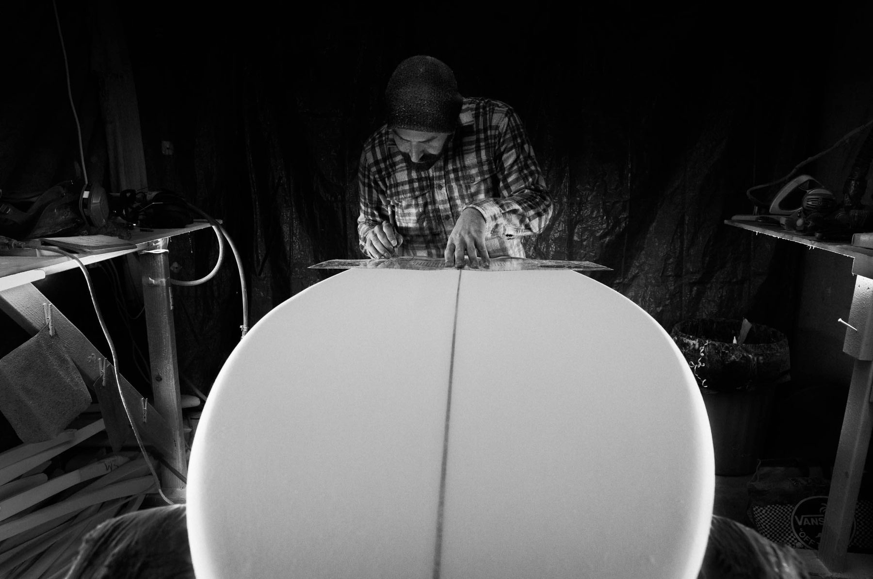 Hand-shaping a surfboard at Lazy Robot