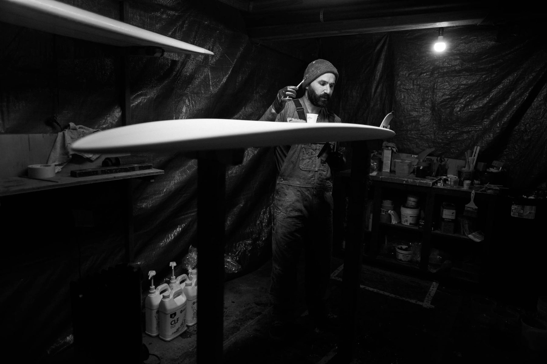 Hand-shaping a surfboard at Lazy Robot
